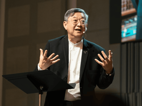 Scientific conference speaker presenting research to an international audience